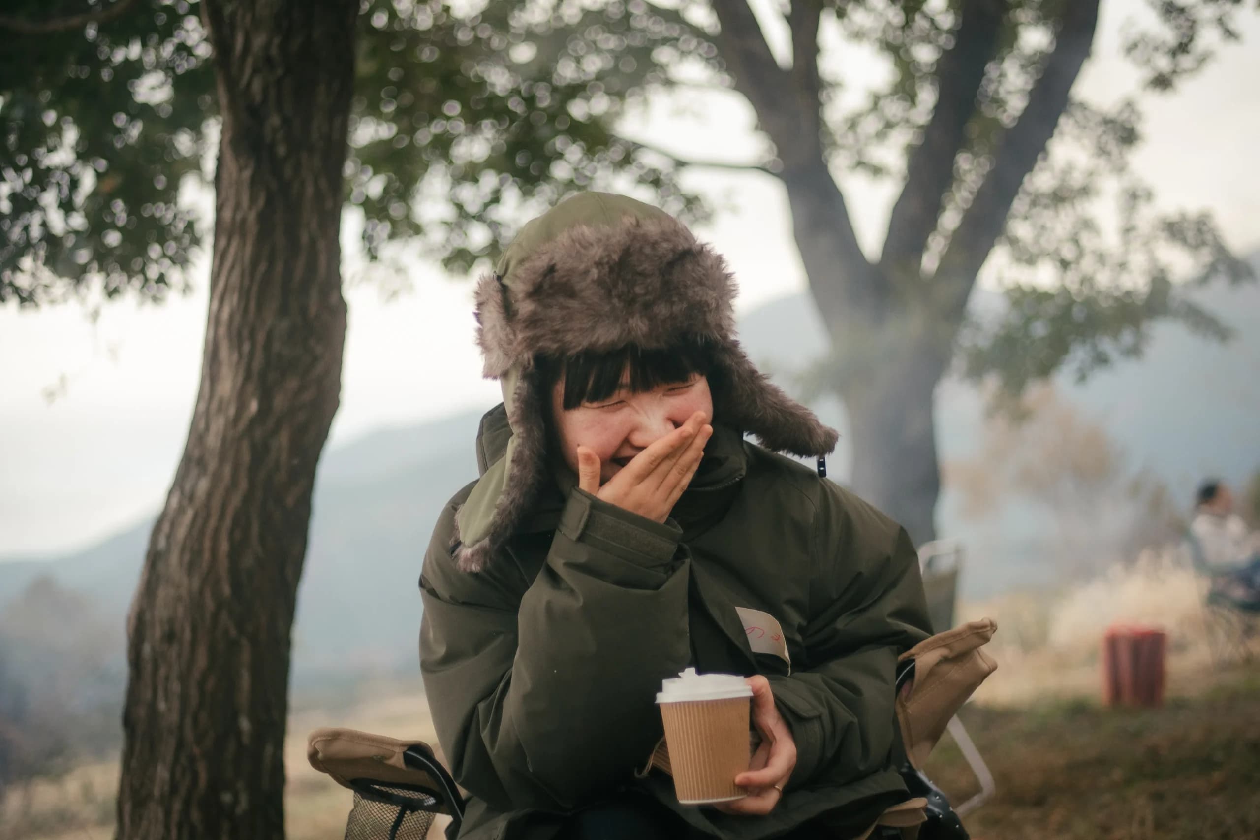 コーヒーカップを手に屋外でくつろぐ参加者